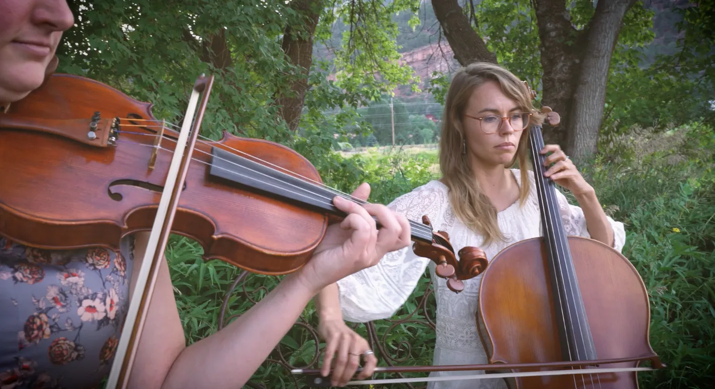 The string duo performing outdoors